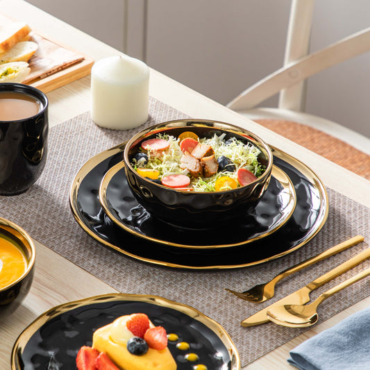 vancasso Lovecasa 16-Piece Dinnerware Set In Black With Elegant Gold Trim. Round Porcelain Pieces With A Sophisticated Design, Ideal For Adding A Touch Of Luxury To Your Table Setting.