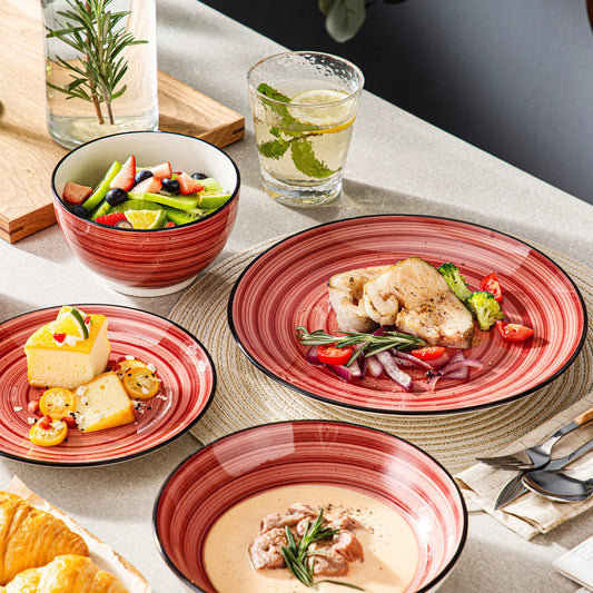 vancasso Bonbon 24-Piece Stoneware Dinnerware Set in Red, with Hand-Painted Designs, Featuring Spiral and Speckled Patterns.