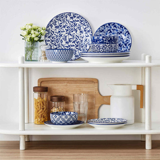 vancasso Selene 12 Piece Porcelain Dinnerware Set, Featuring Deep Indigo Japanese Floral Vine Patterns And Modern Geometric Lines, With Durable Packaging Ensuring Safe Delivery.