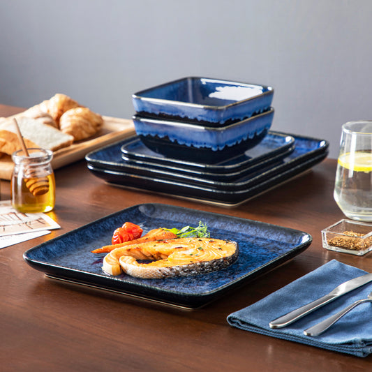 vancasso Stern 12-Piece Stoneware Dinnerware Set In Bold Blue With Artistic Patterns, Perfect For Adding A Statement Touch To Your Table, Complemented By Neutral Tones And Gold Cutlery.