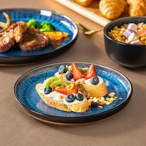 Playa 12-Piece Stoneware Dinnerware Set with plates and bowls for 4 - featuring a unique blue reactive glaze and a farmhouse-inspired style-vancasso