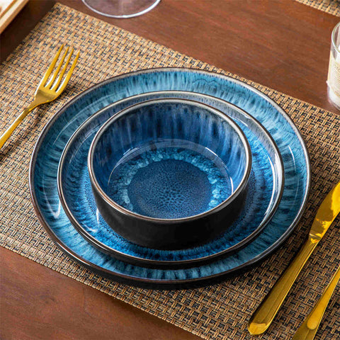 Playa 12-Piece Stoneware Dinnerware Set with plates and bowls for 4 - featuring a unique blue reactive glaze and a farmhouse-inspired style-vancasso