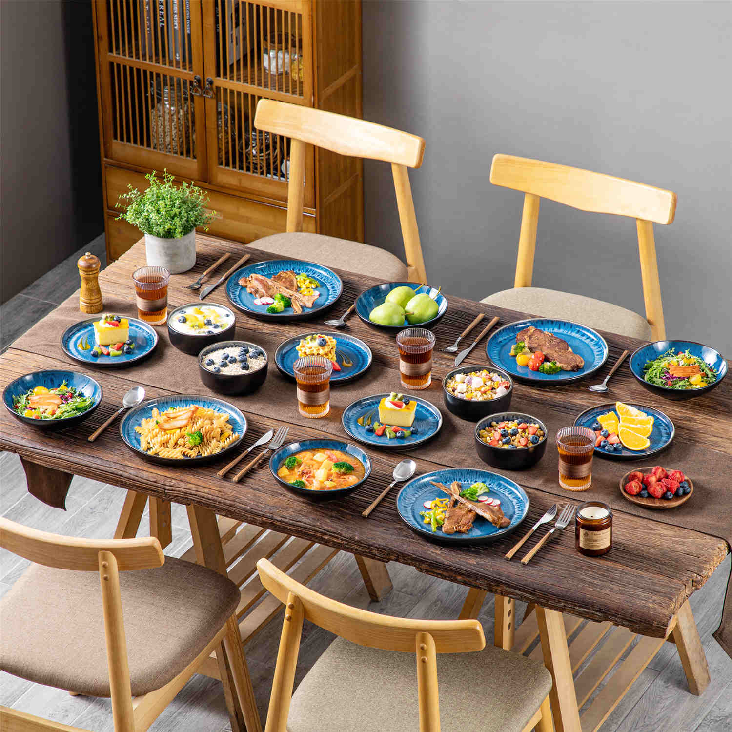 A glossy blue 16-piece stoneware dinnerware set from the Playa collection - featuring farmhouse charm with plates and bowls for 4 people-vancasso