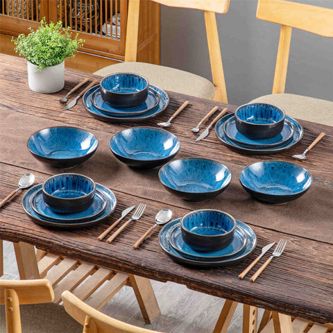 A glossy blue 16-piece stoneware dinnerware set from the Playa collection - featuring farmhouse charm with plates and bowls for 4 people-vancasso