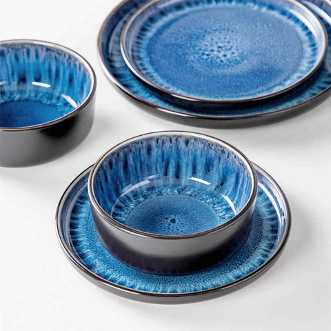 A glossy blue 24-piece stoneware dinnerware set from the Playa collection - featuring farmhouse charm with plates and bowls for 6 people-vancasso