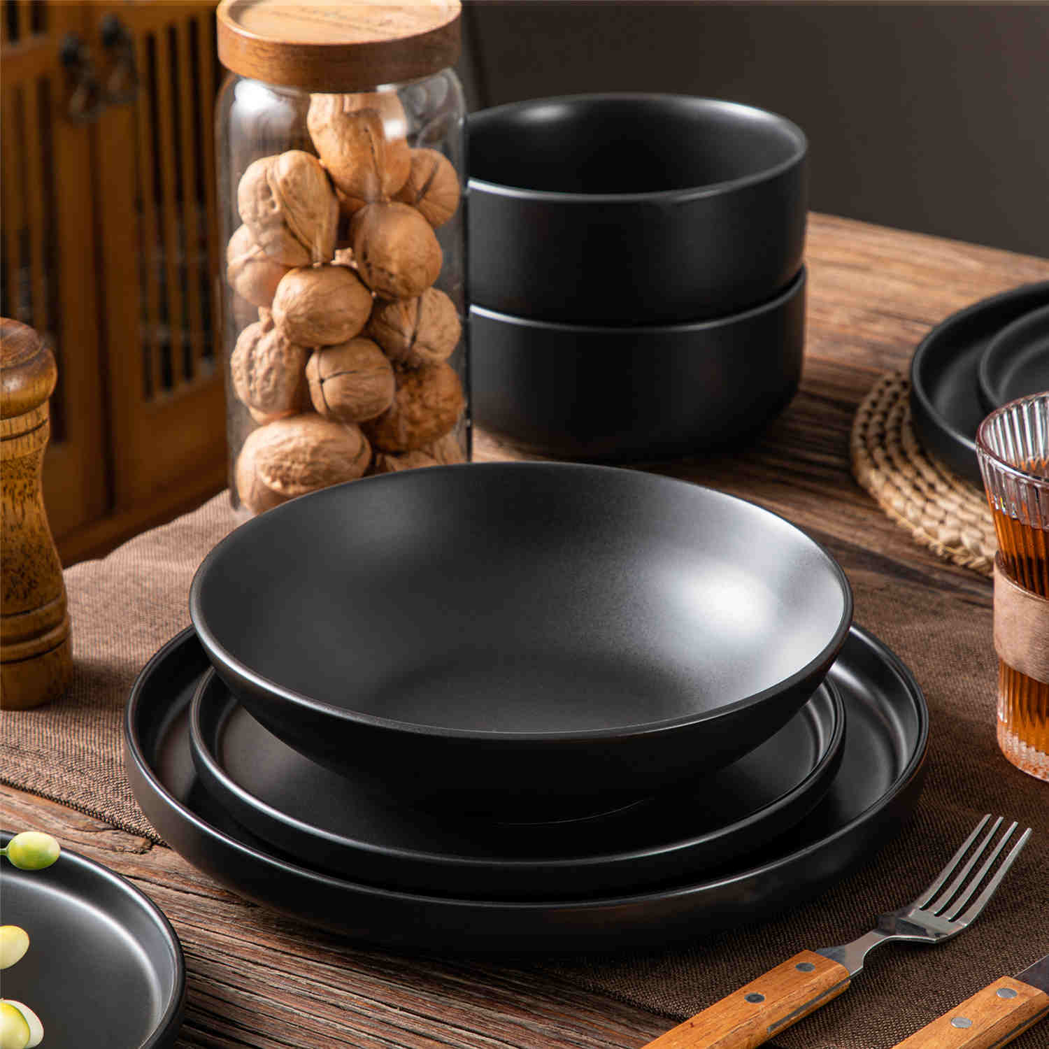 A matte black 16-piece stoneware dinnerware set from the Playa collection - offering a modern touch with plates and bowls for 4 people-vancasso.