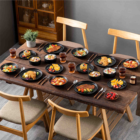 A matte black 16-piece stoneware dinnerware set from the Playa collection - offering a modern touch with plates and bowls for 4 people-vancasso.