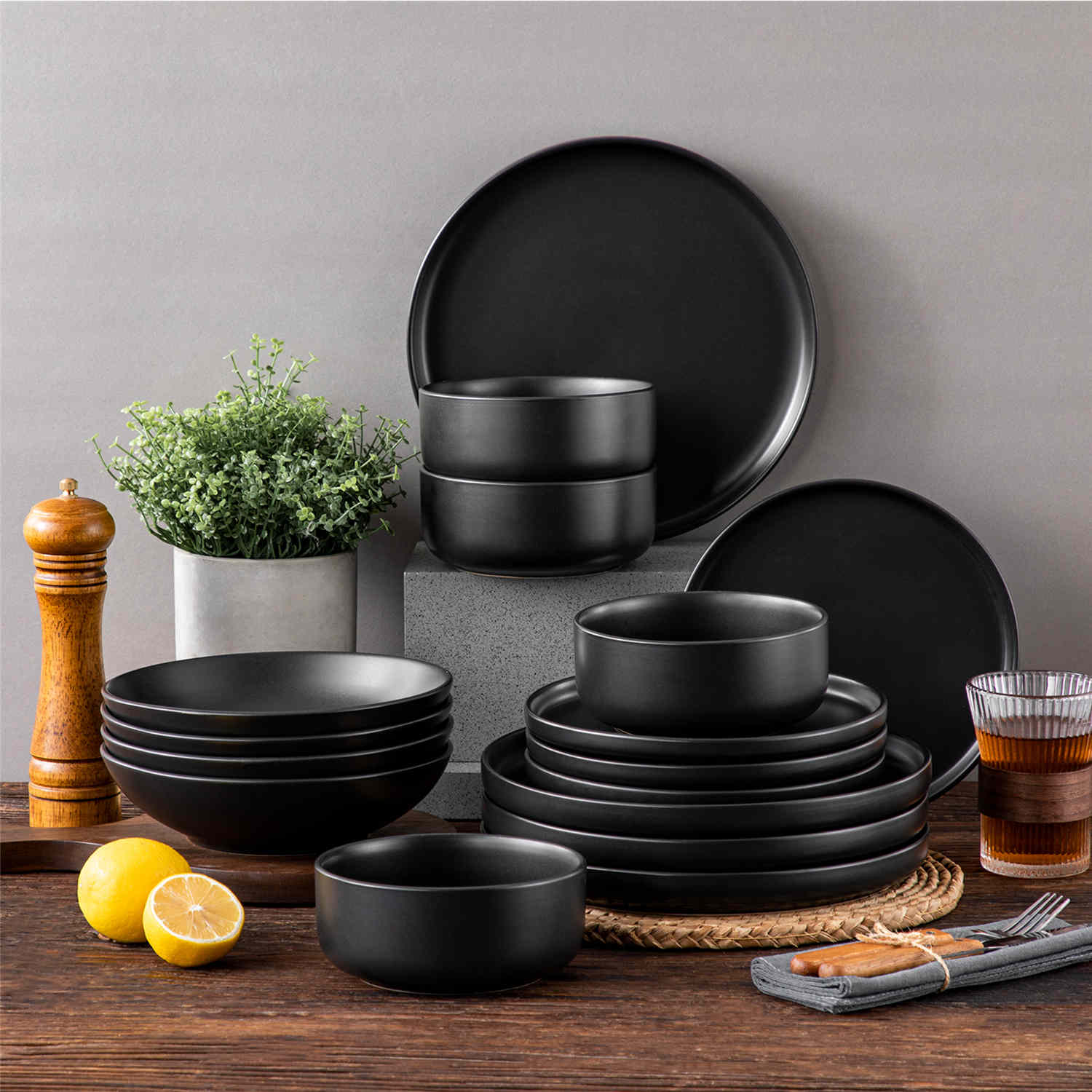 A matte black 16-piece stoneware dinnerware set from the Playa collection - offering a modern touch with plates and bowls for 4 people-vancasso.