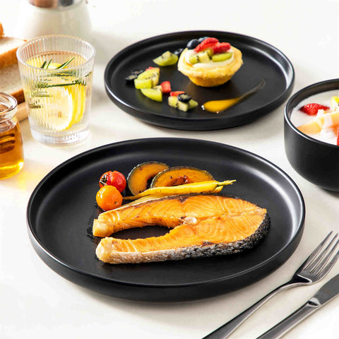 Playa 18-Piece Stoneware Dinnerware Set for 6, featuring plates and bowls in a modern Ibiza-inspired style with a matte black finish-vancasso