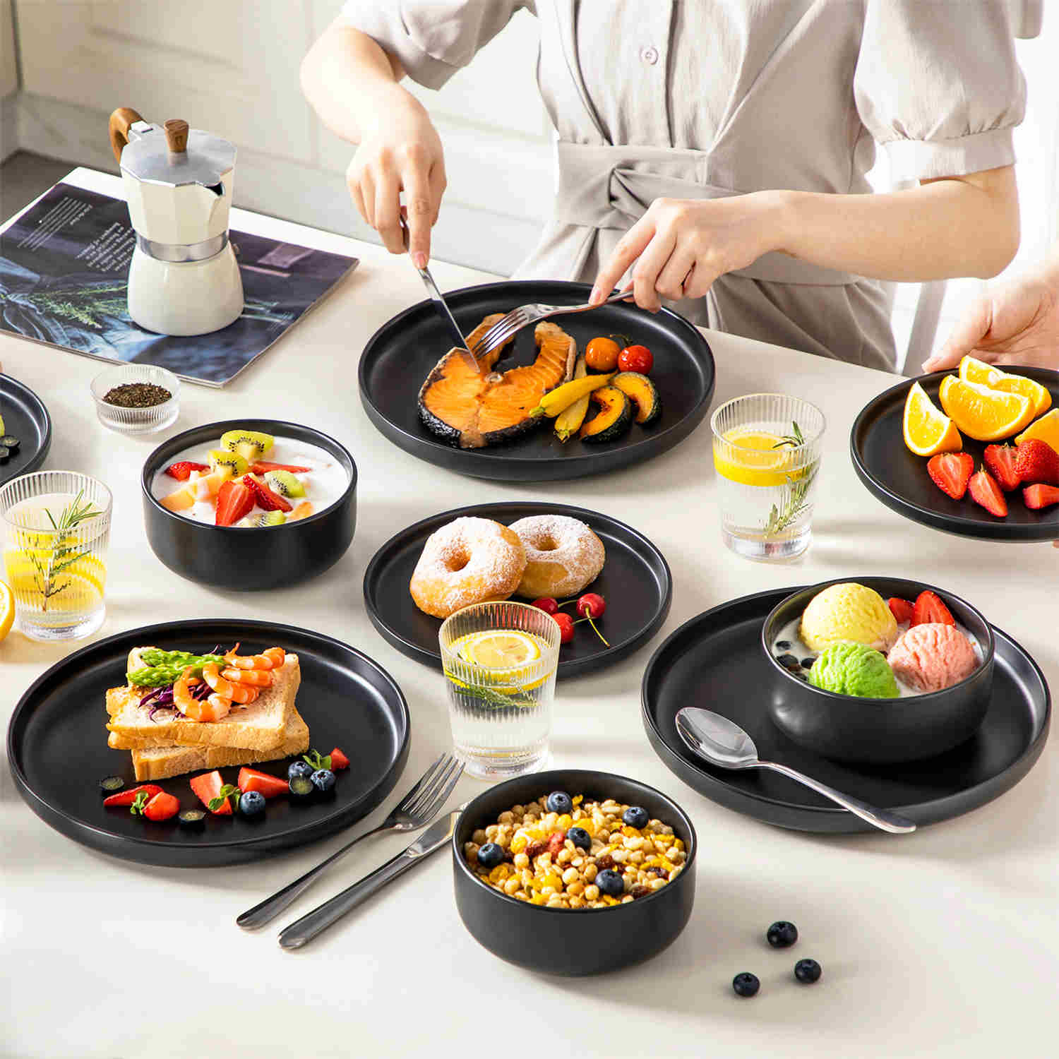 Playa 18-Piece Stoneware Dinnerware Set for 6, featuring plates and bowls in a modern Ibiza-inspired style with a matte black finish-vancasso