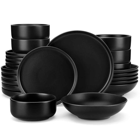 A matte black 24-piece stoneware dinnerware set from the Playa collection by vancasso - adding a modern flair with plates and bowls for 6 people.