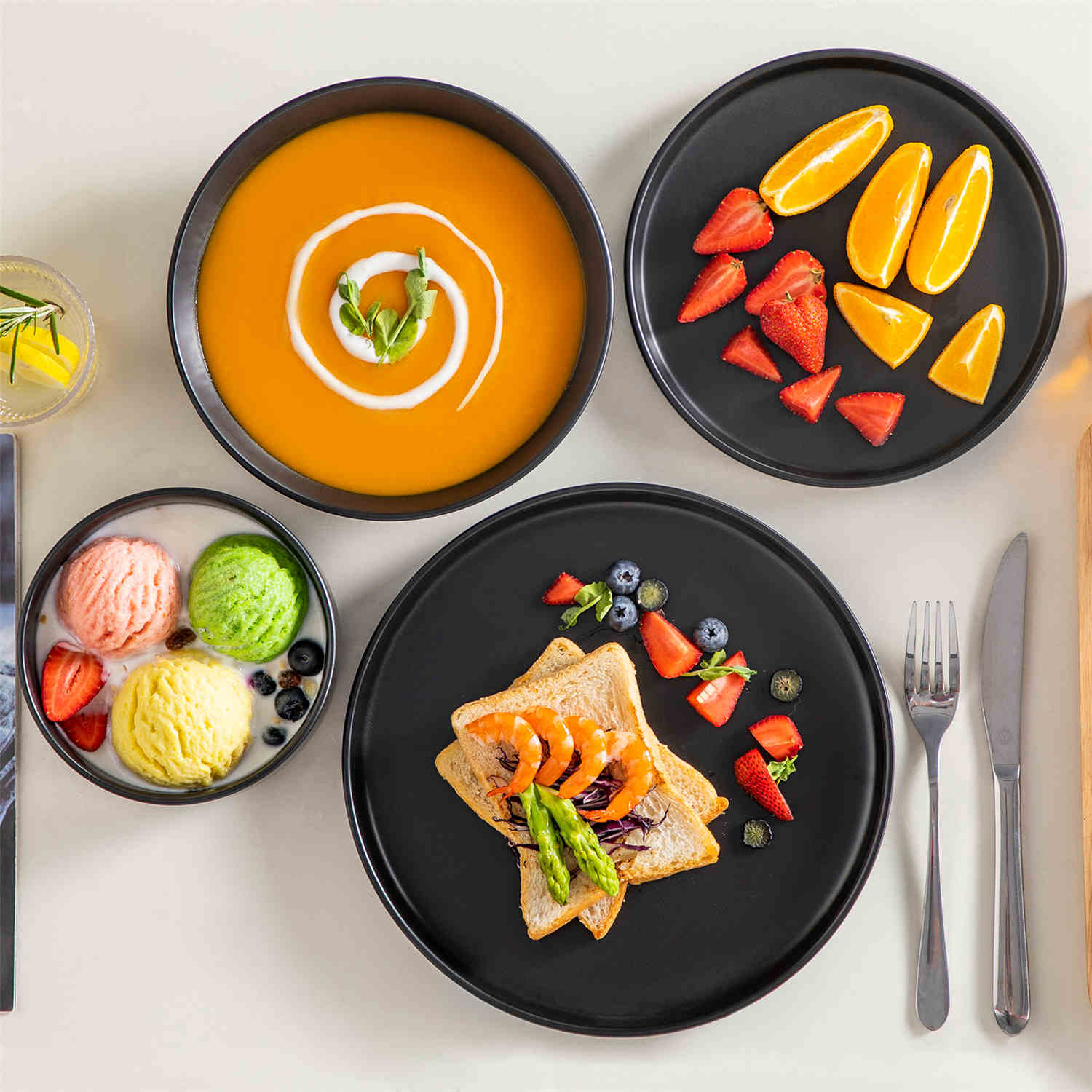 A matte black 24-piece stoneware dinnerware set from the Playa collection by vancasso - adding a modern flair with plates and bowls for 6 people.