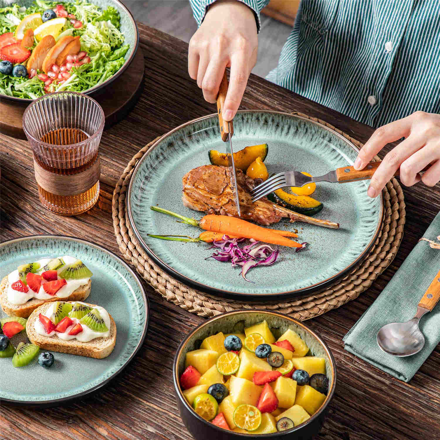 A glossy dark green 24-piece stoneware dinnerware set from the Playa collection - featuring farmhouse charm with plates and bowls for 6 people-vancasso