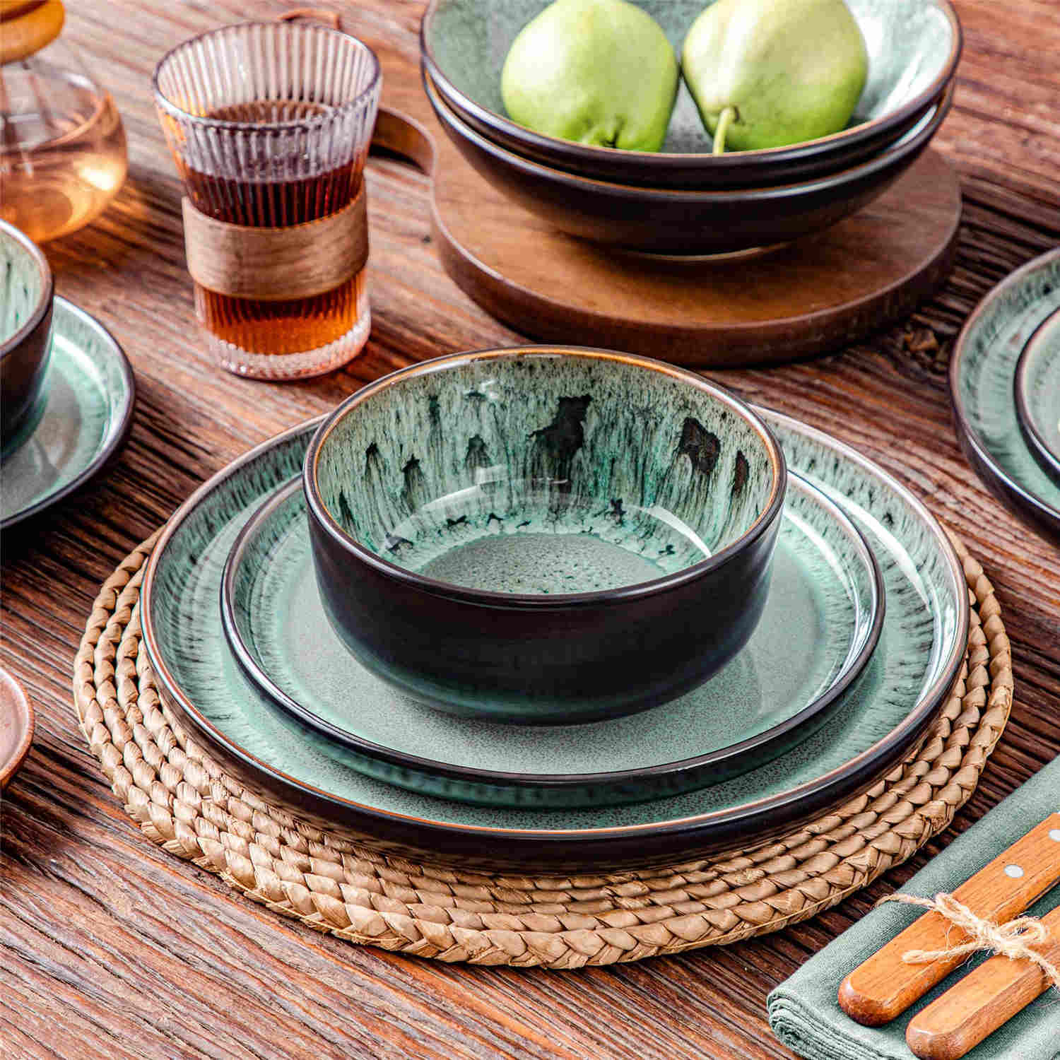 A glossy dark green 24-piece stoneware dinnerware set from the Playa collection - featuring farmhouse charm with plates and bowls for 6 people-vancasso