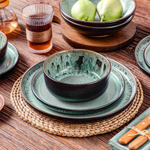 A glossy dark green 24-piece stoneware dinnerware set from the Playa collection - featuring farmhouse charm with plates and bowls for 6 people-vancasso