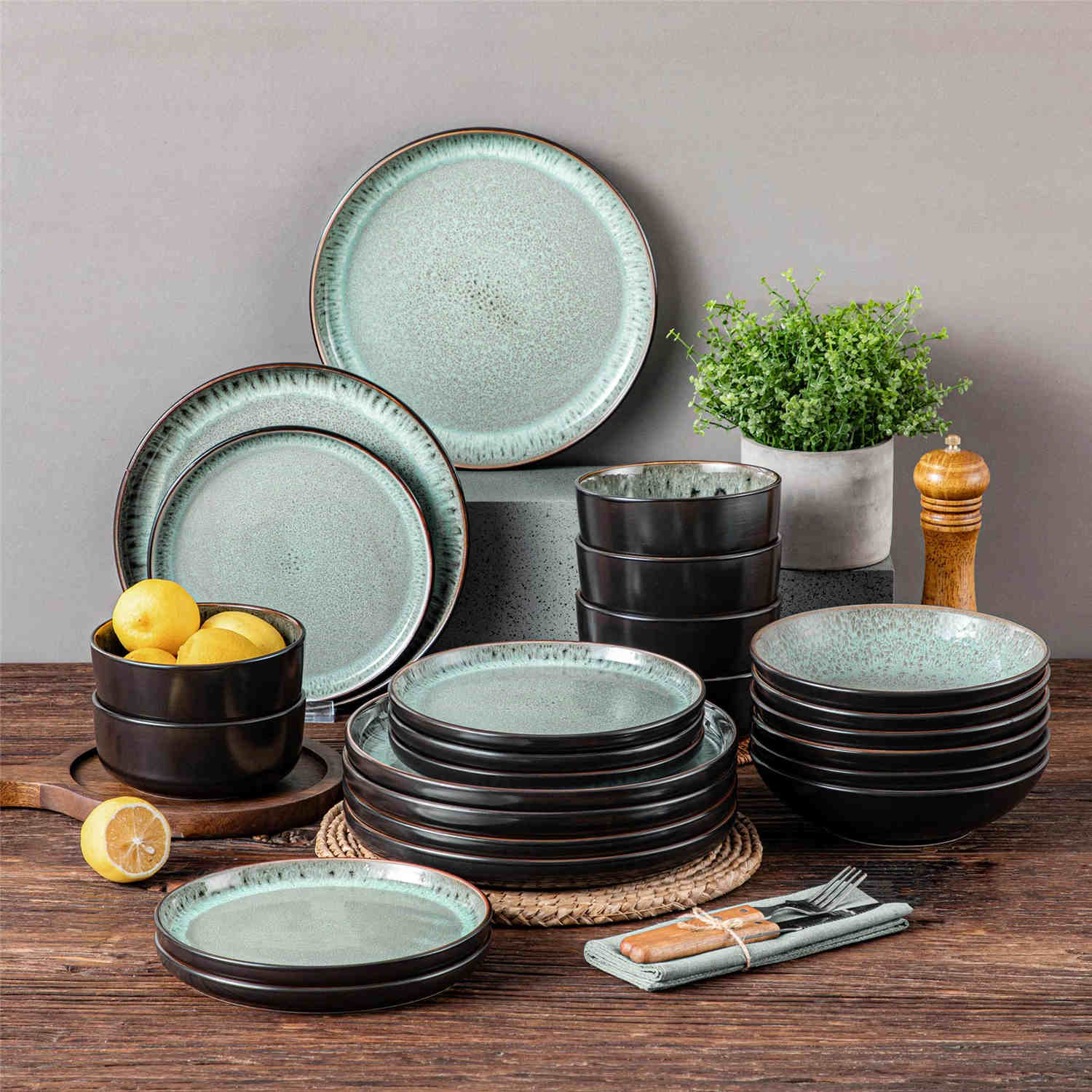 A glossy dark green 24-piece stoneware dinnerware set from the Playa collection - featuring farmhouse charm with plates and bowls for 6 people-vancasso