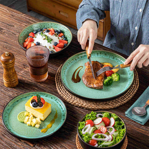 A glossy light green 16-piece stoneware dinnerware set from the Playa collection - featuring farmhouse charm with plates and bowls for 4 people-vancasso