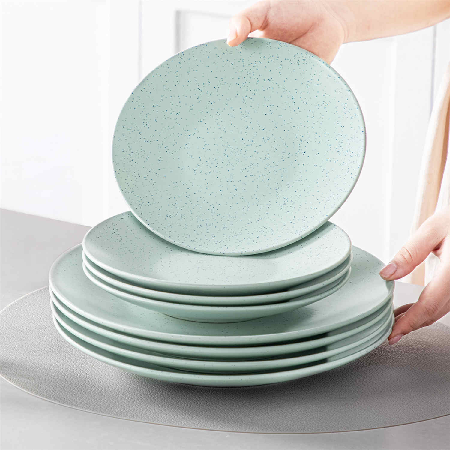 The Sabine 12-Piece Stoneware Dinnerware Set features a semi-matte finish and a modern round design in light grey - providing service for 4 with both plates and bowls-vancasso