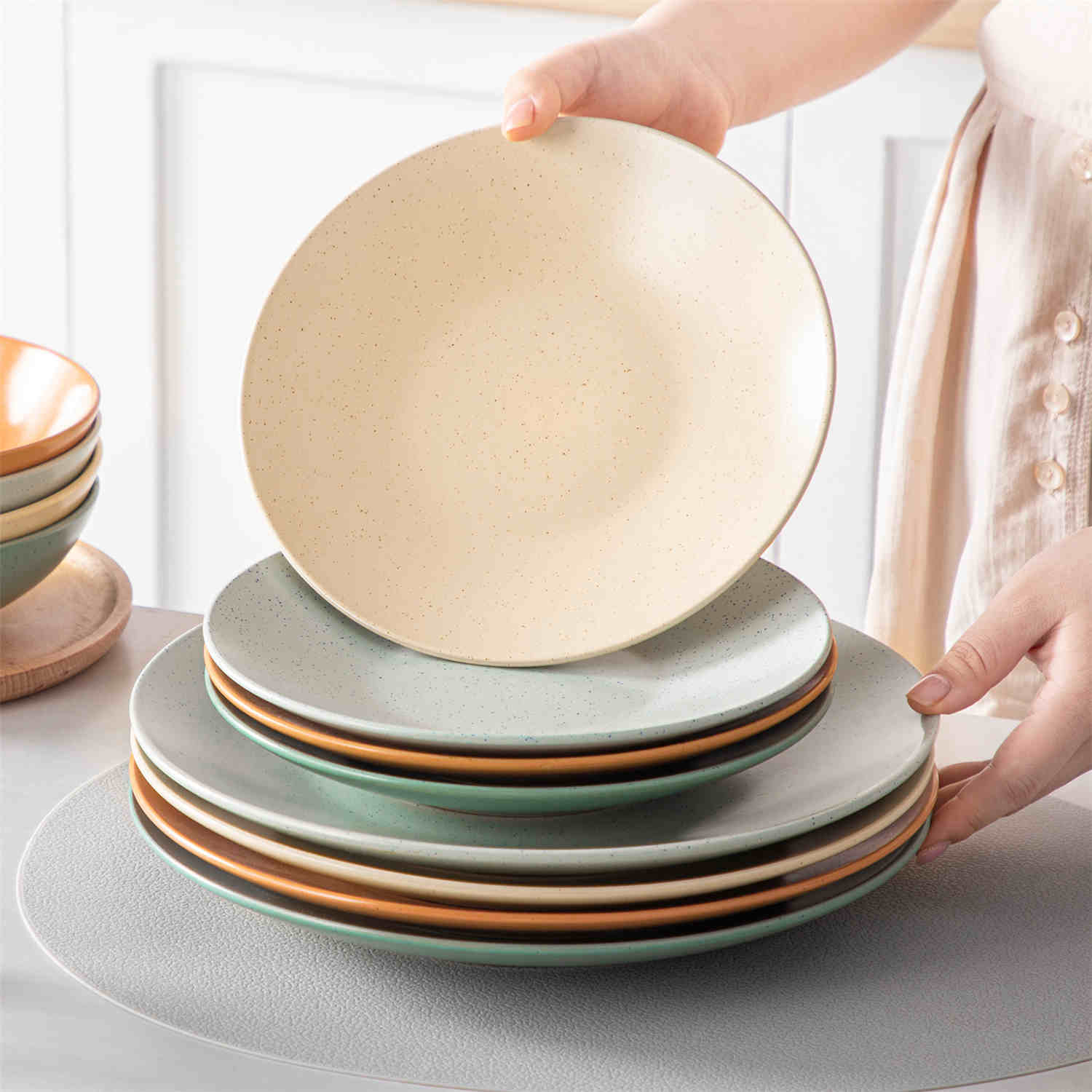 The Sabine 12-Piece Stoneware Dinnerware Set features a semi-matte finish and a modern round design in multicolor - providing service for 4 with both plates and bowls-vancasso