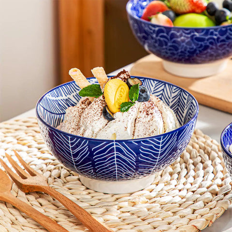 Takaki Cereal Bowls Set of 4 featuring geometric floral patterns in deep navy blue - offering a chic Japanese-inspired touch, filled with hearty oatmeal-vancasso